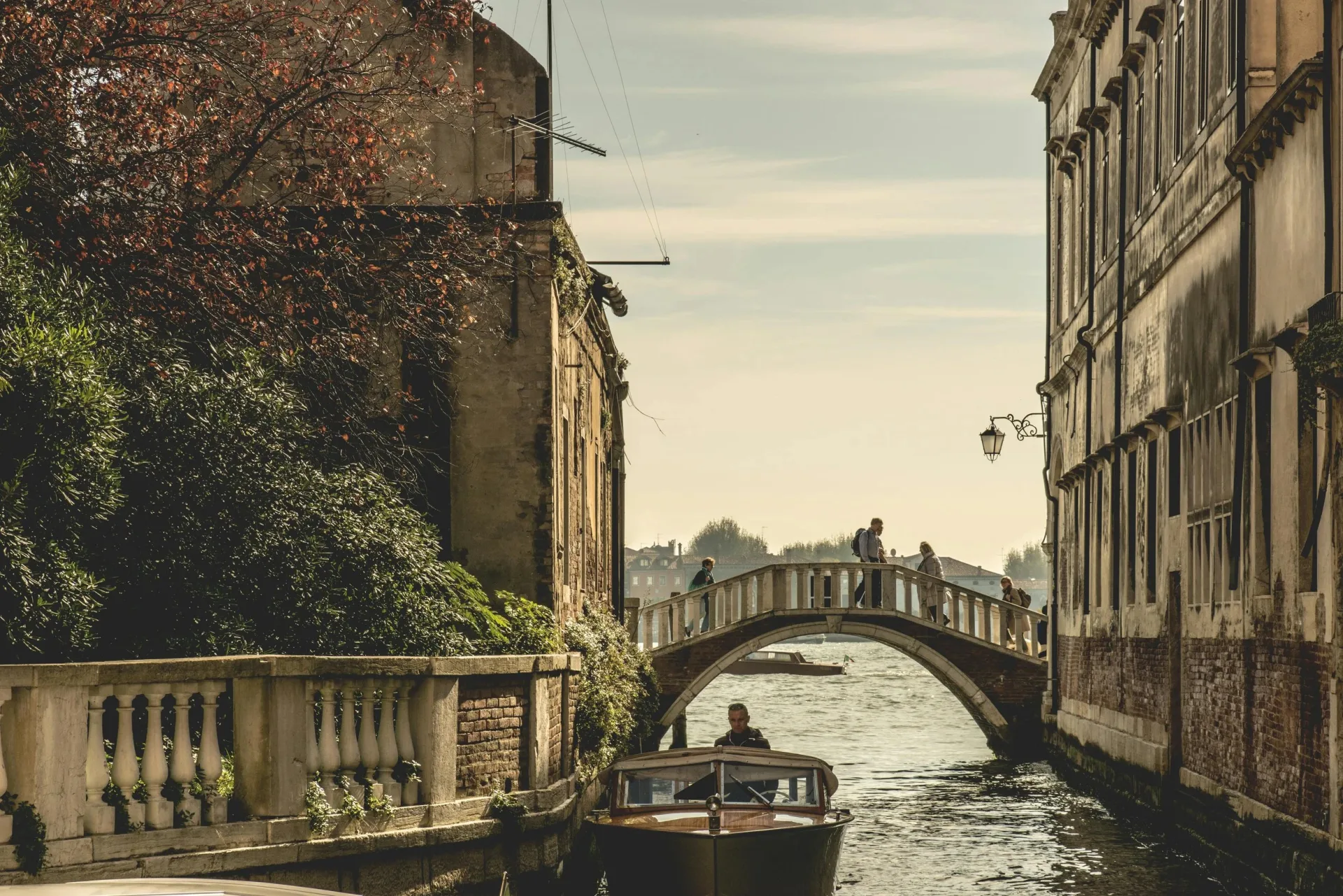Venice canal with a stone bridge and traditional boat